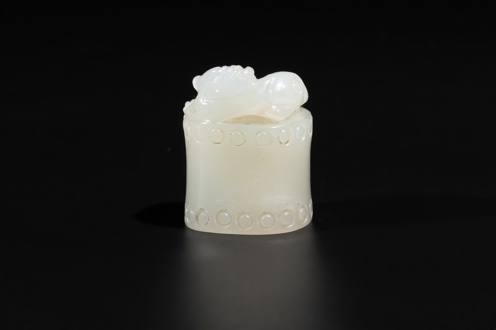 A Chinese white jade carving of a chilong reclining on bamboo, Qing