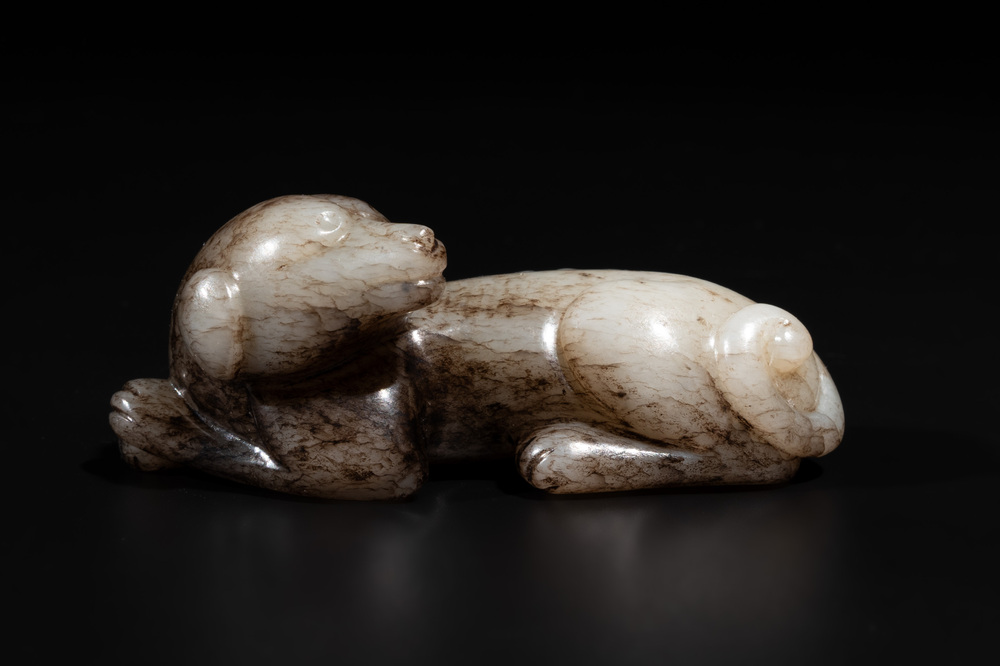 A Chinese partly black coloured white jade dog carving, Qing