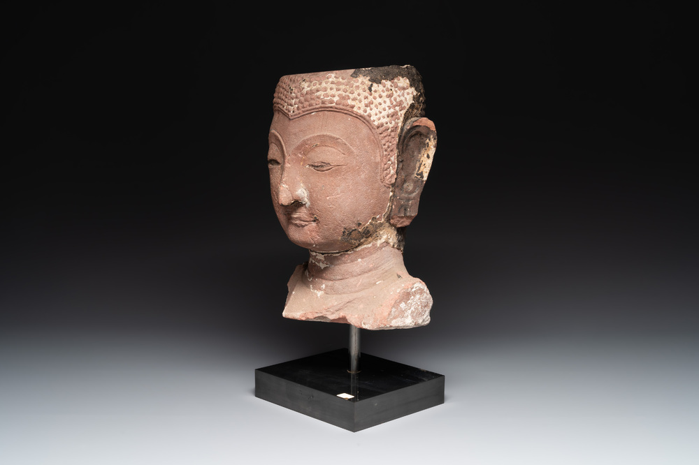 A Thai red sandstone head of Buddha, possibly Ayutthaya period, 15th C.