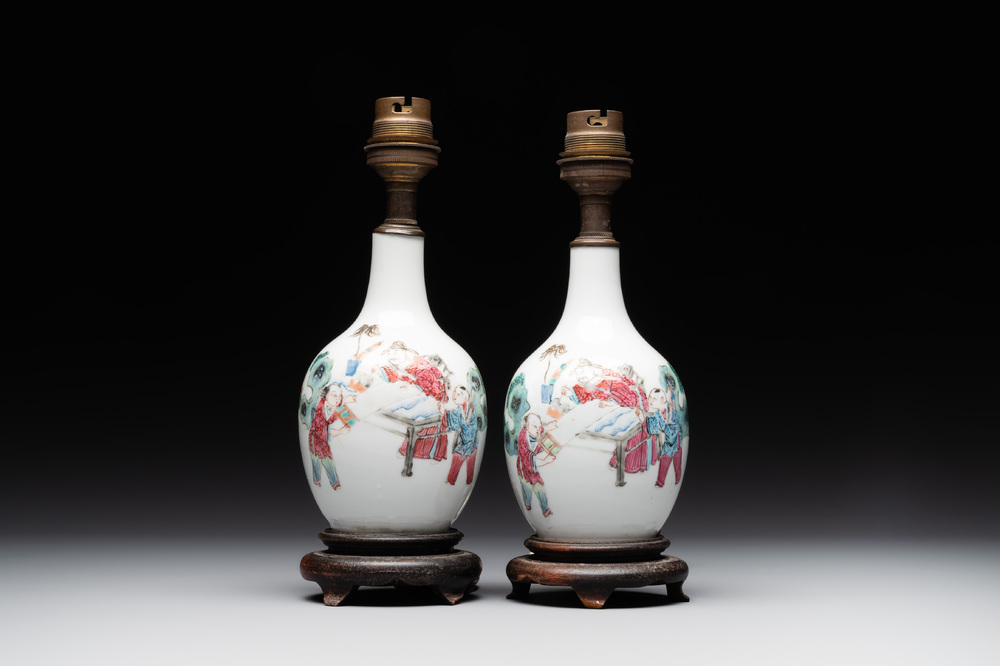 A pair of Chinese famille rose vases with figural design mounted as lamps, 19th C.