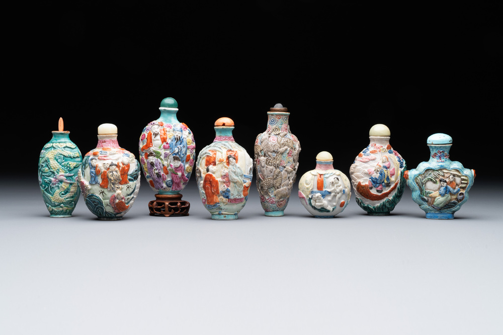 Eight Chinese moulded famille rose snuff bottles, Qianlong mark, 19th C.