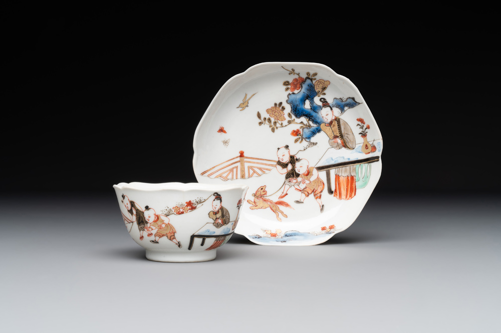 A Chinese polychrome cup and saucer with figures and a dog, Yongzheng