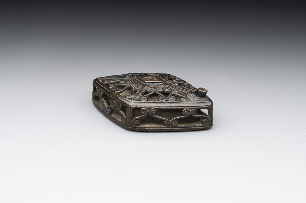 A Chinese reticulated lozenge-shaped double-walled bronze water dropper, 16th C.