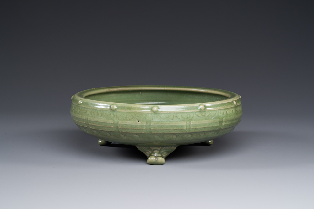A Chinese Longquan celadon tripod censer on wooden stand, Yuan/Ming