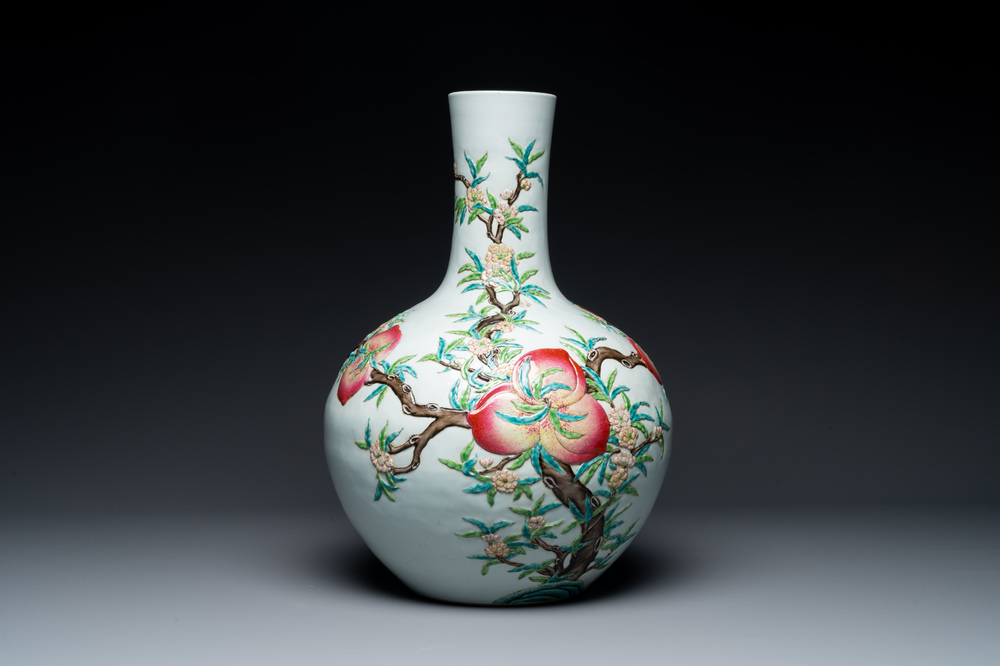 A Chinese famille rose relief-moulded 'tianqiuping' vase with nine peaches, Qianlong mark, 19/20th C.
