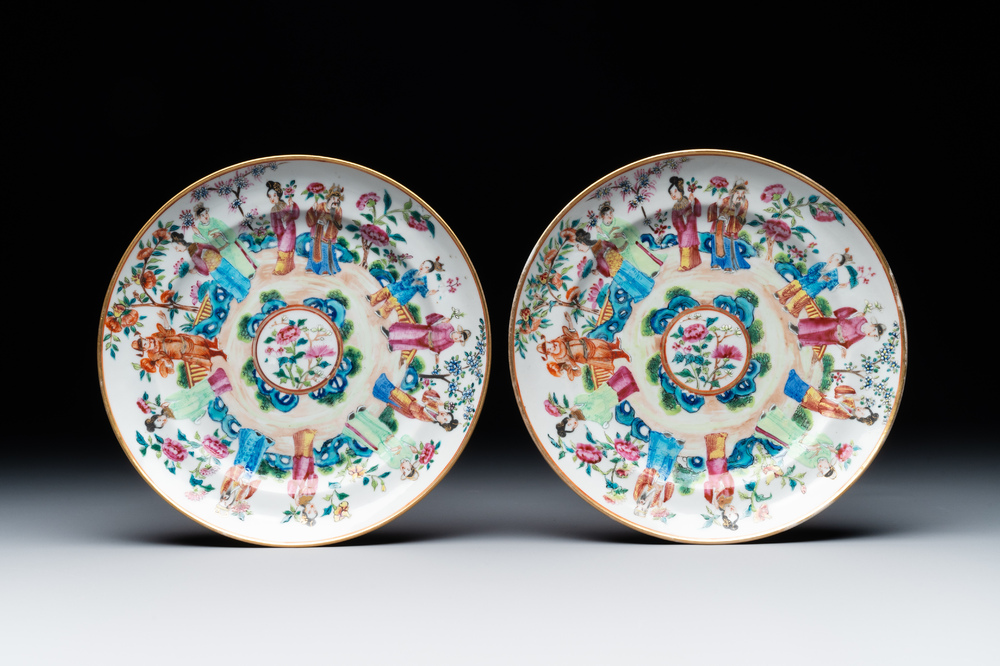 A pair of Chinese Canton famille rose plates with figures in a garden, 19th C.