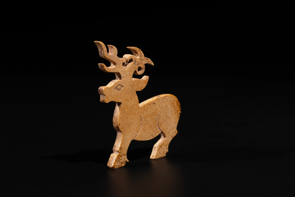 A rare Chinese calcified jade 'deer' pendant, Western Zhou