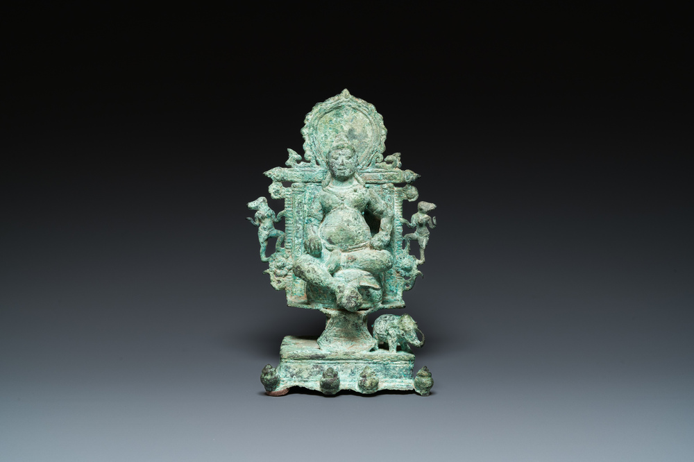 A bronze group with Kubera on throne, Central Java, Indonesia, 11/12th C.