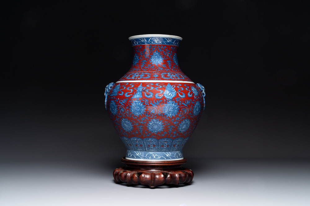 A Chinese blue, white and iron-red 'bajixiang' 'hu' vase on wooden stand, Qianlong mark, 19th C.