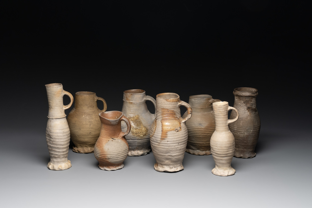 A collection of 8 German proto stoneware ribbed jugs, including 'Jacobakans', 14th C.