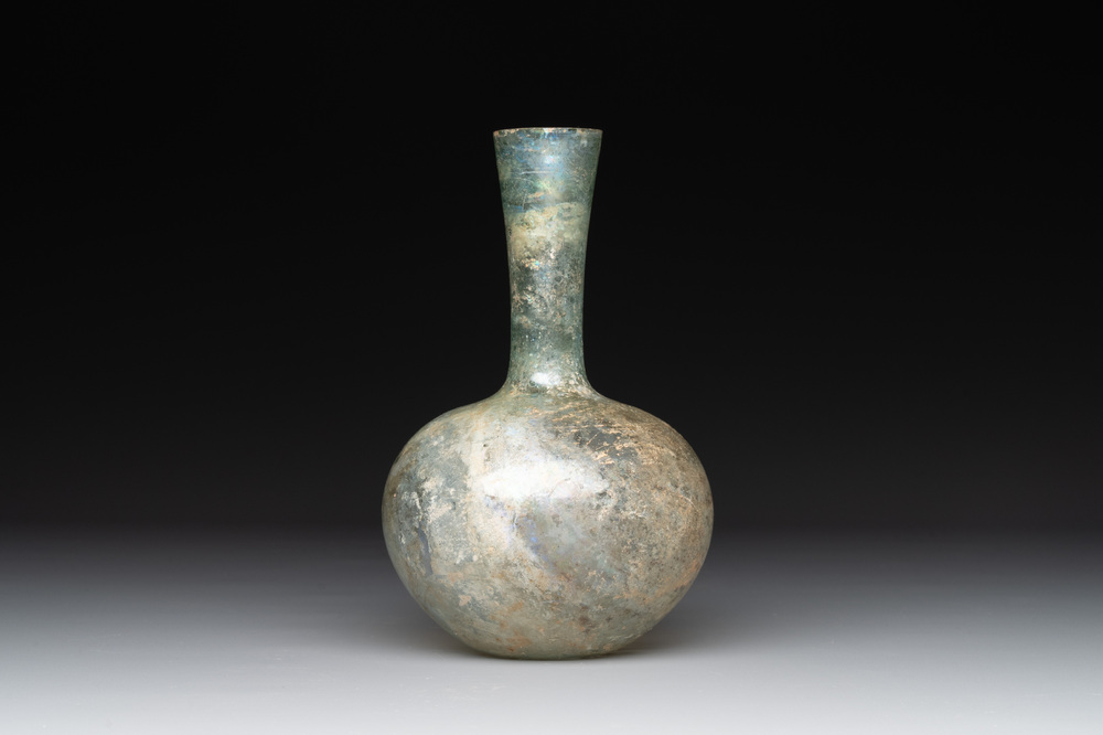 A Roman glass bottle with a conical neck, 4/5th C.