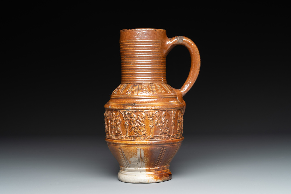 A Raeren stoneware 'peasant dance' jug, late 16th C.