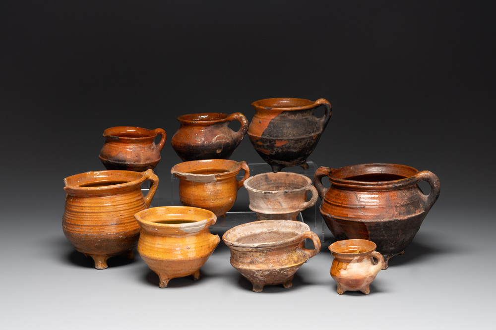 A collection of 10 parcel-glazed pottery so-called &lsquo;grapen&rsquo;, tripod cooking pots, 14th/17th C.