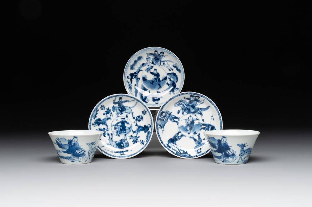 Two Chinese blue and white cups and three saucers with figural design, Kangxi and later