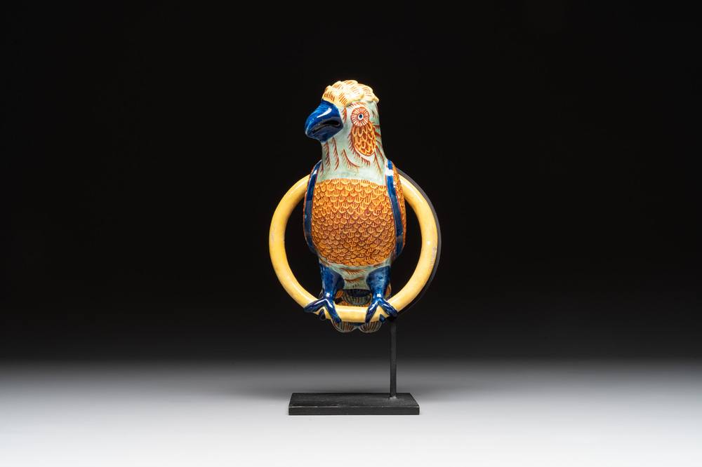 A polychrome Dutch Delft parrot on a later metal stand, 18/19th C.