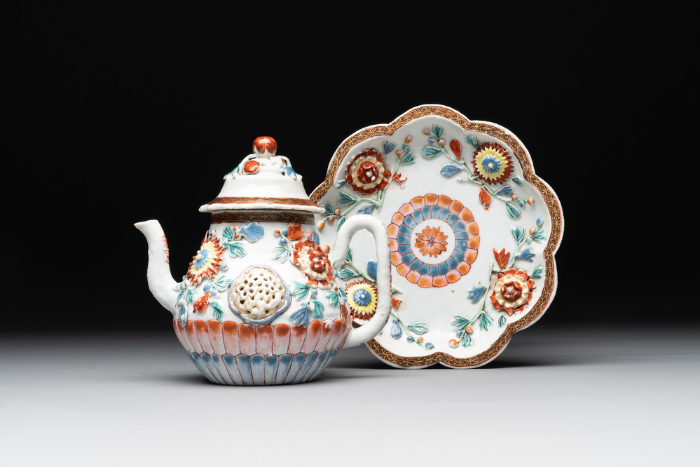 A Chinese famille rose teapot and stand with floral relief design, Qianlong