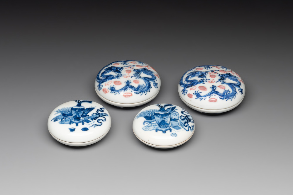 A pair of Chinese blue and white and a pair of blue, white and copper-red seal paste boxes, Kangxi and Qianlong mark, 19th C.