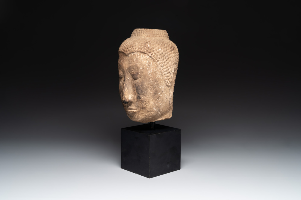 A Thai sandstone head of Buddha, possibly Ayutthaya period, 14/15th C.