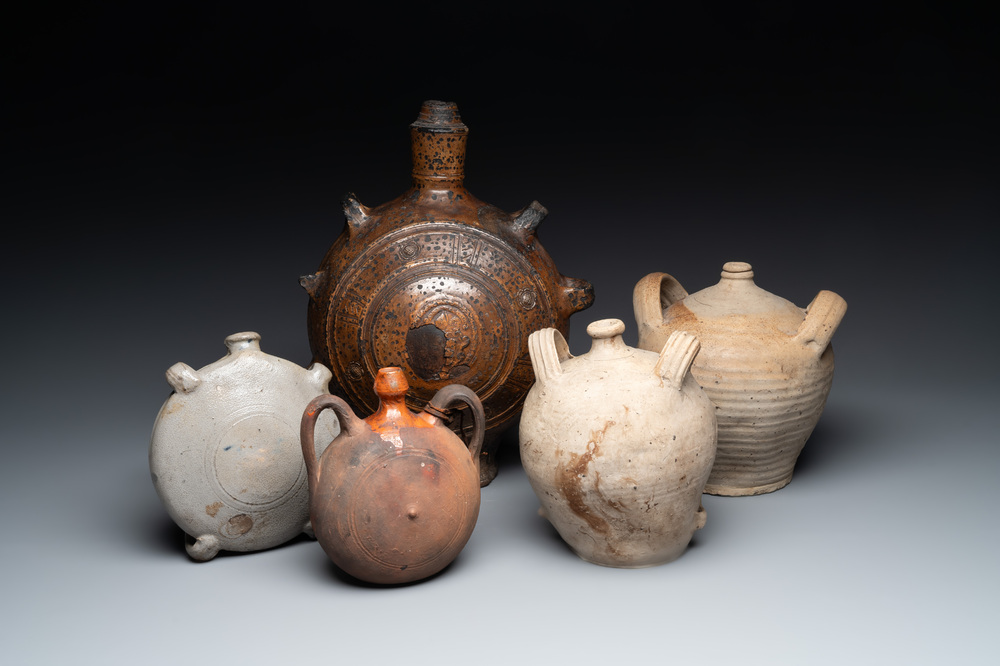 Five stoneware jugs or pilgrim flasks, including a Raeren example with armorial design, 16/17th C. and later