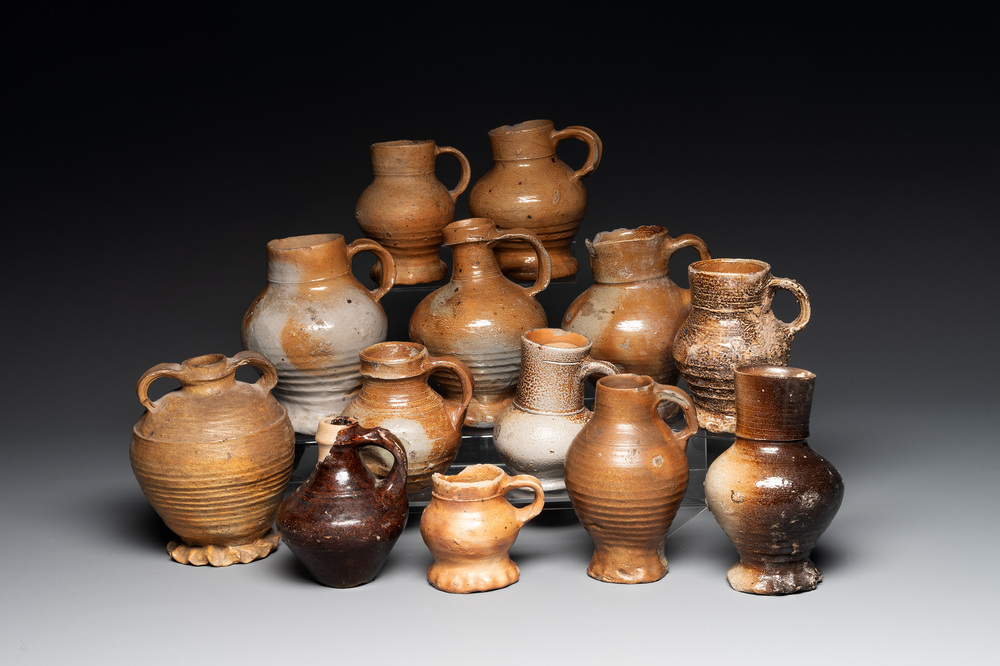 A collection of 13 German stoneware jugs, 15th C. and later