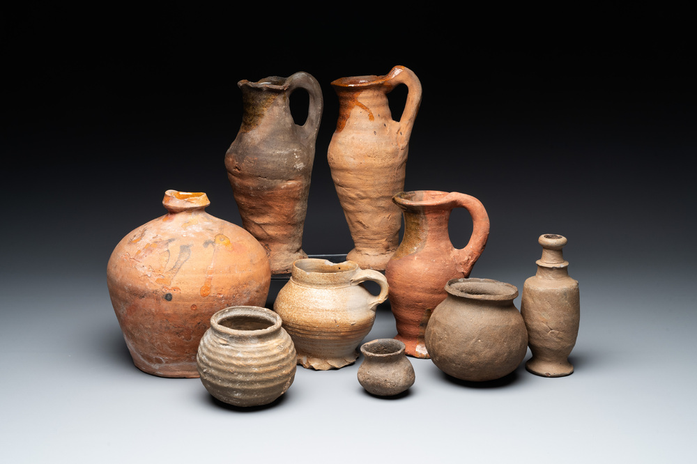 A collection of 9 German proto stoneware jugs and vessels, 14th C.