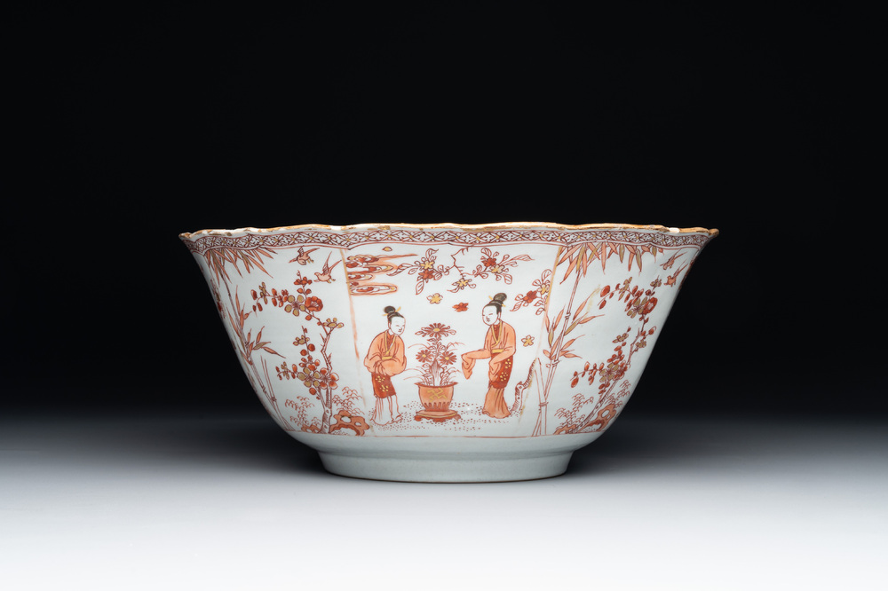 A Chinese iron-red and gilt-decorated 'ladies in a garden' bowl, Kangxi
