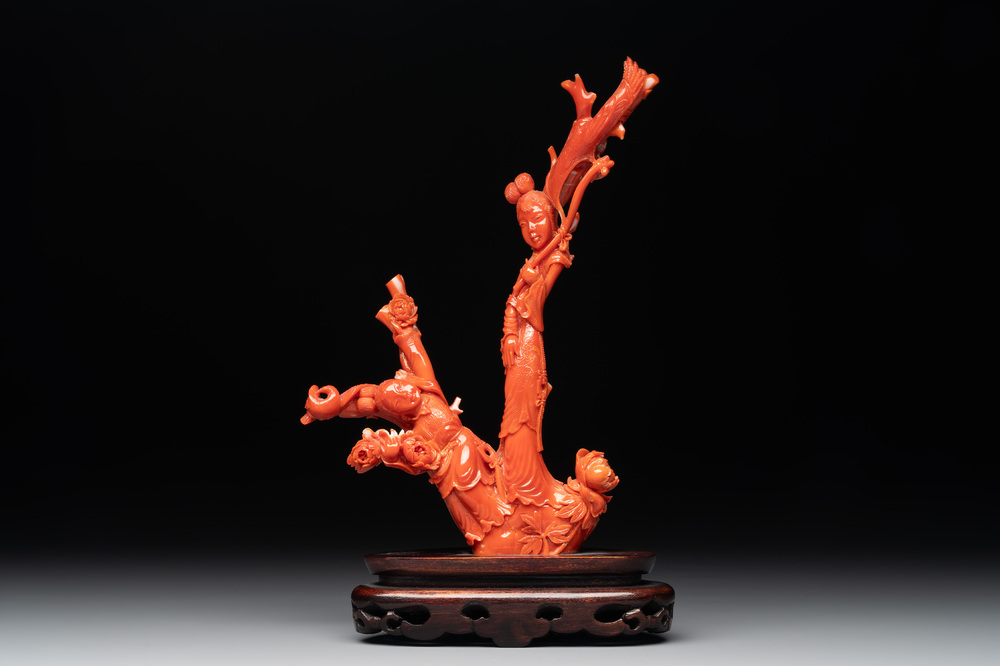 A Chinese carved red coral group with goddesses on wooden stand, 19/20th C.