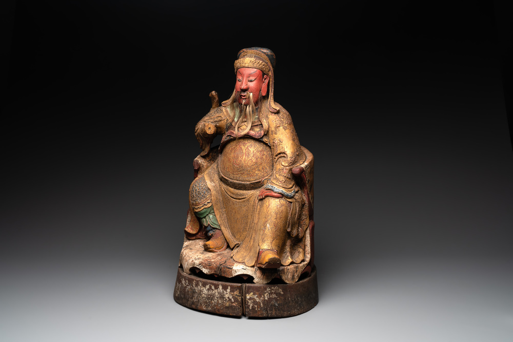 A large Chinese gilt- and polychromed wooden sculpture of a divinity, 19th C.