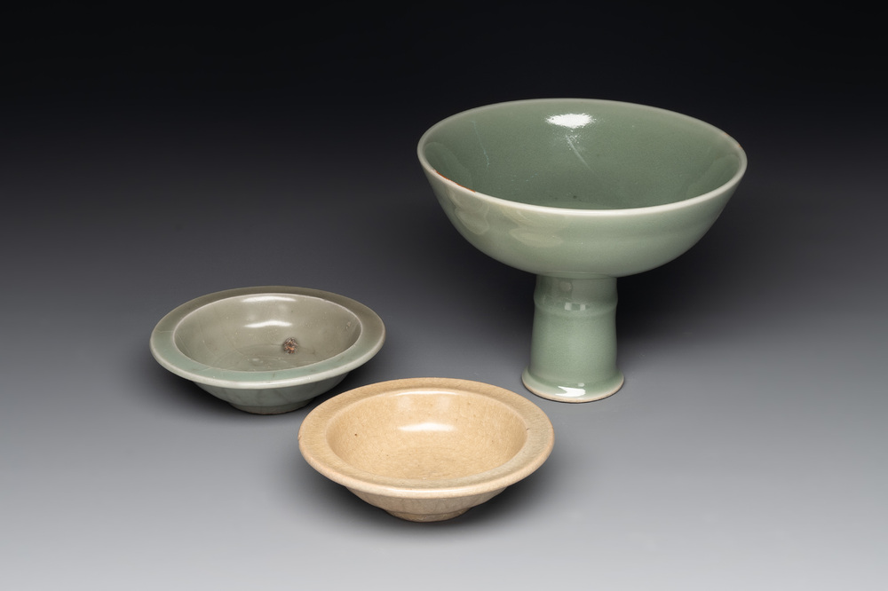 A Chinese Longquan celadon stem cup and two saucers, Ming