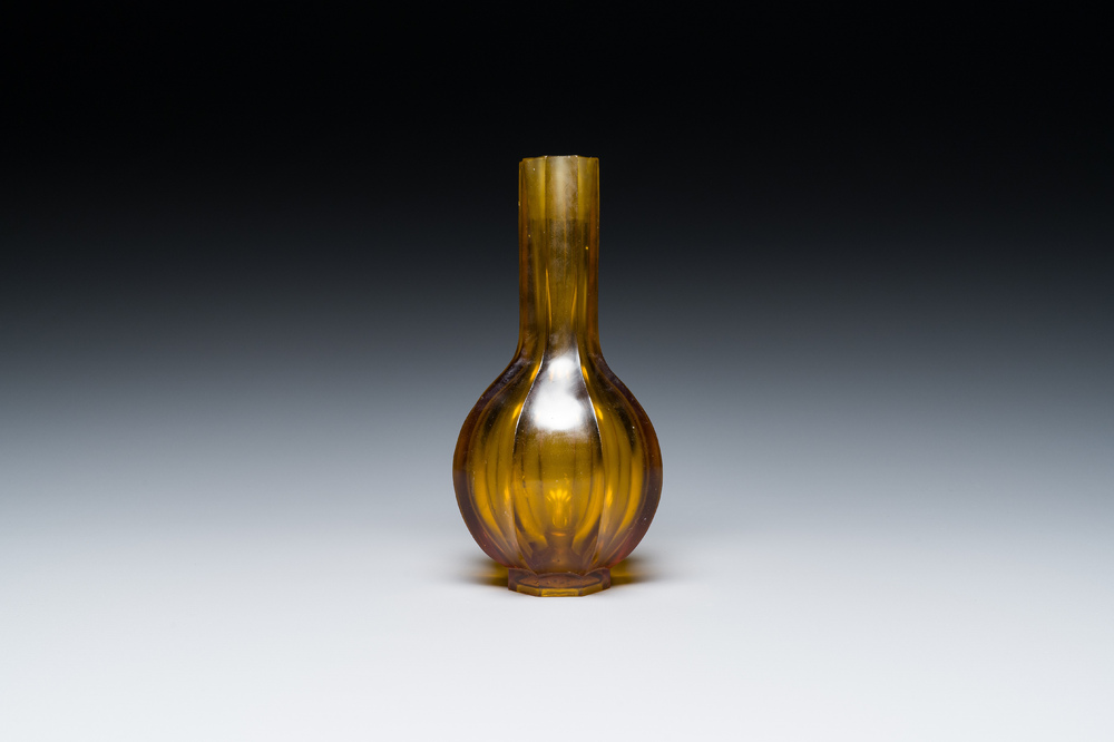 A Chinese facetted translucent amber-coloured Peking glass bottle vase, Qianlong mark, 19th C.
