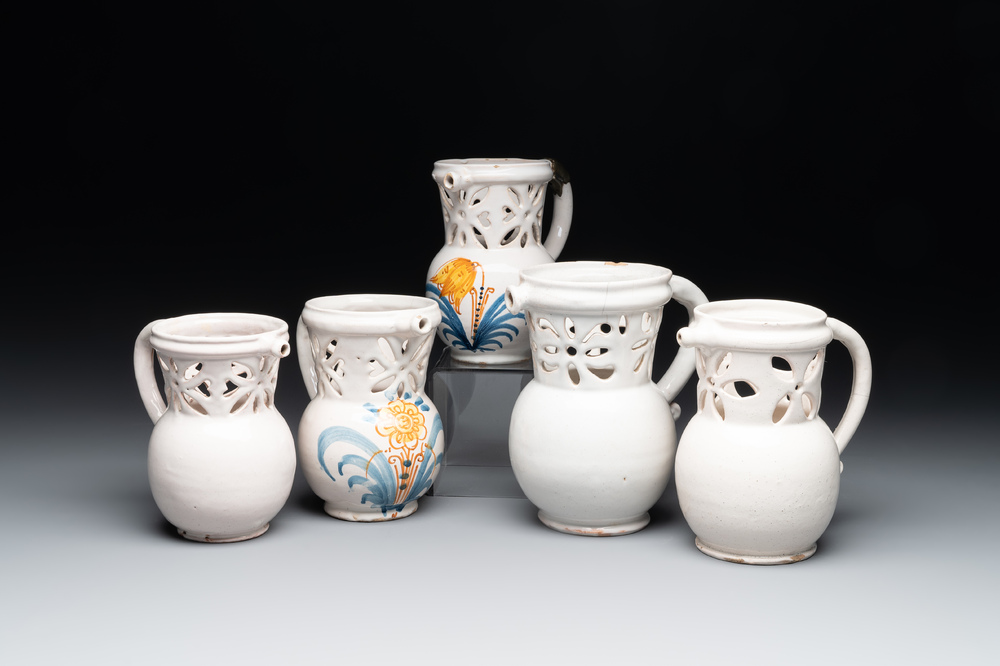 Three French white-glazed and two polychrome puzzle jugs, Nevers, 18th C.