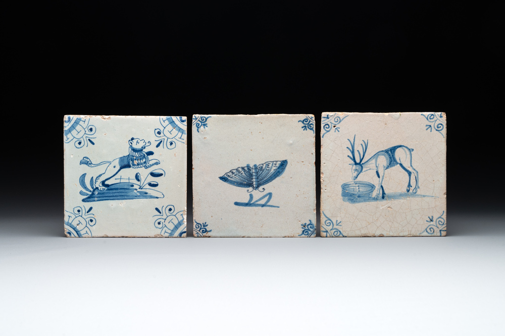 Three blue and white Dutch Delft tiles with a lion, a butterfly and a deer, 17th C.