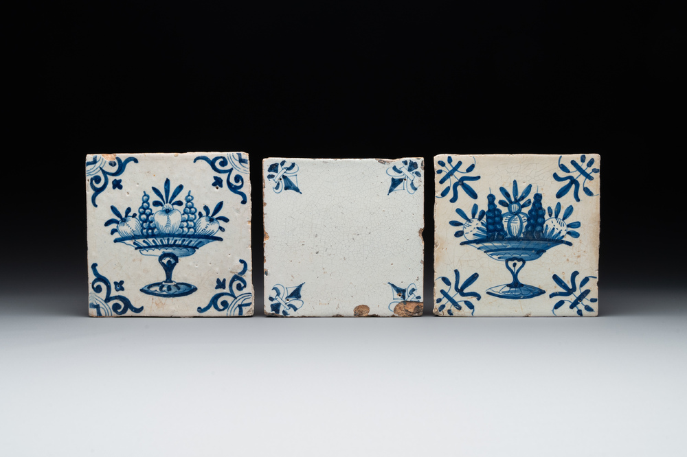 A rare 'empty' blue and white Dutch Delft tile and two 'fruit bowl' tiles, 17th C.