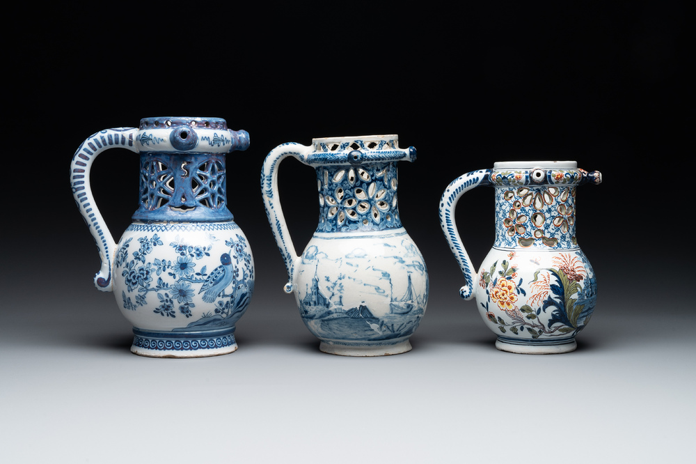 Two blue and white and one polychrome Dutch Delft puzzle jugs, dated 1734 and 1705, 18th C. and later