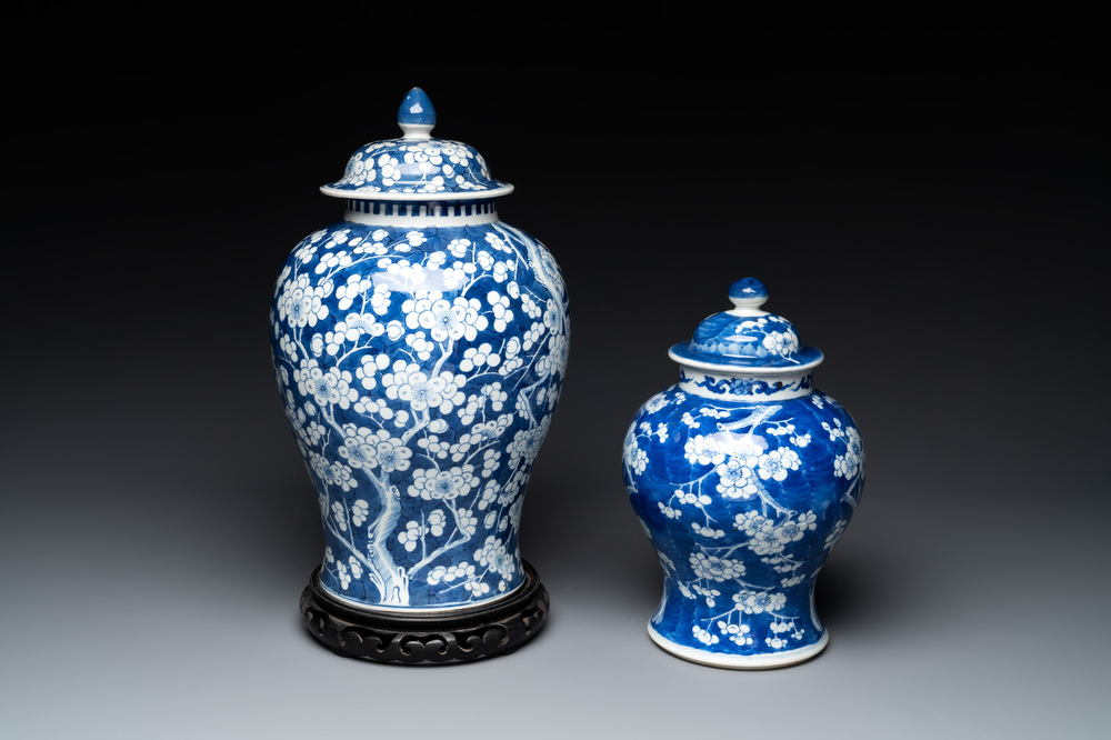Two Chinese blue and white 'prunus on cracked ice' vases and covers, Kangxi mark, 19th C.