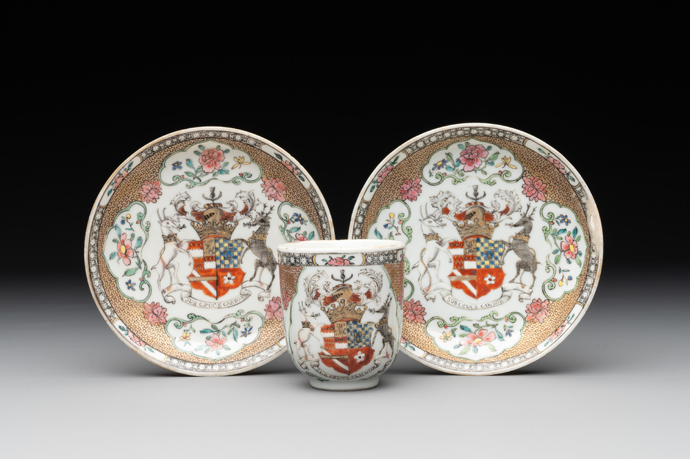 A fine Chinese famille rose armorial cup and two saucers, Yongzheng/Qianlong