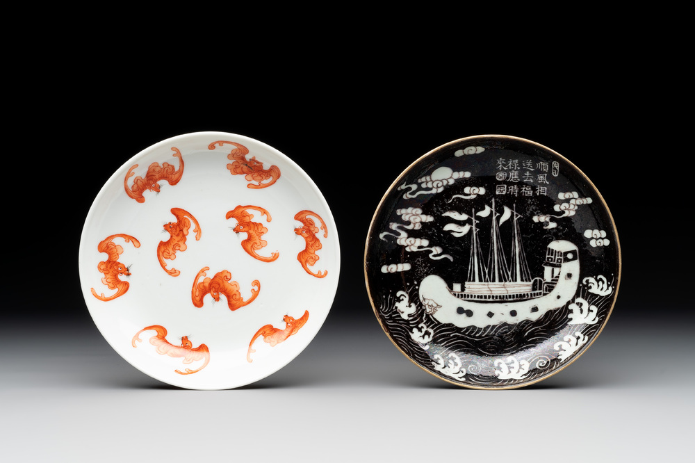 A Chinese iron-red 'bat' saucer and a black-glazed 'ship' saucer with calligraphy, Guangxu mark, 19th C.
