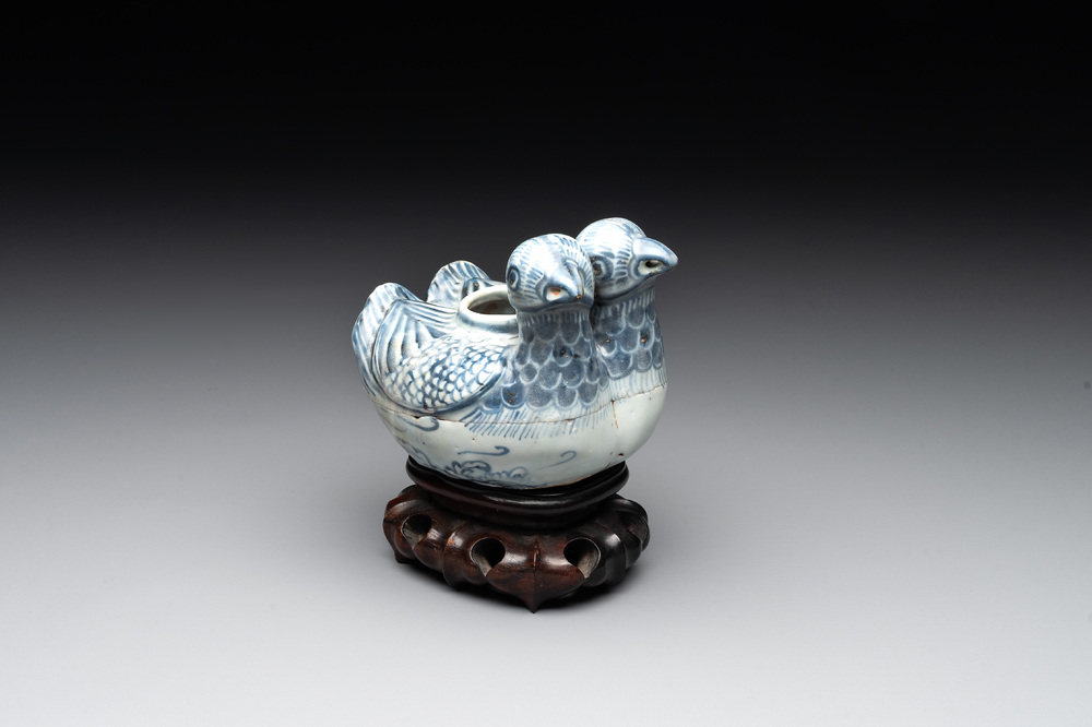 A Chinese blue and white 'double mandarin duck' ewer or water dropper on wooden stand, Ming, ca. 1500