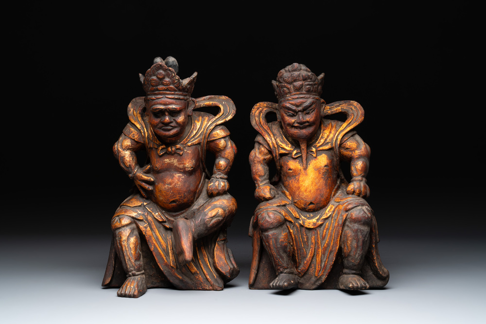 A pair of Chinese gilt-lacquered wooden sculptures of guardians, Qing