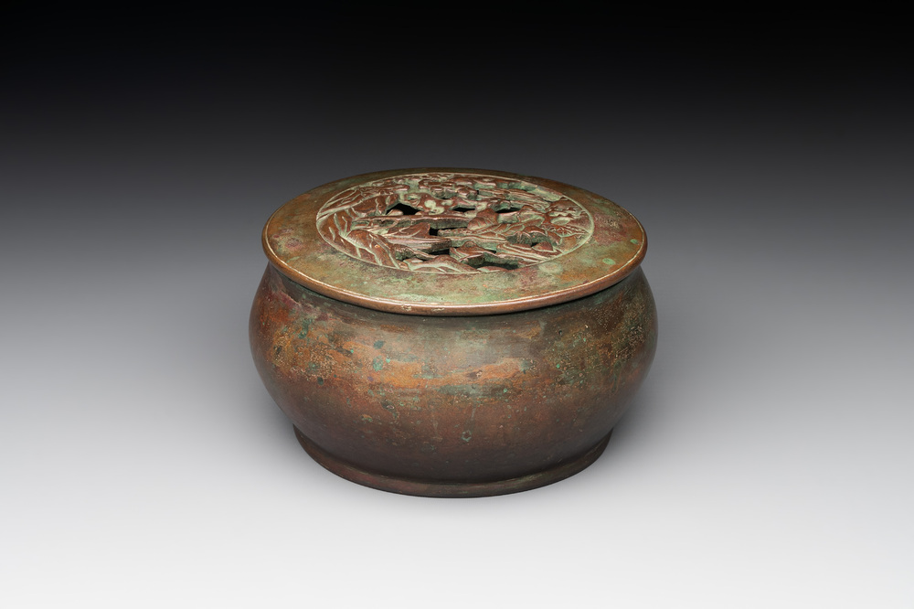 A rare Chinese bronze 'sage in a mountainous landscape' handwarmer, 17/18th C.