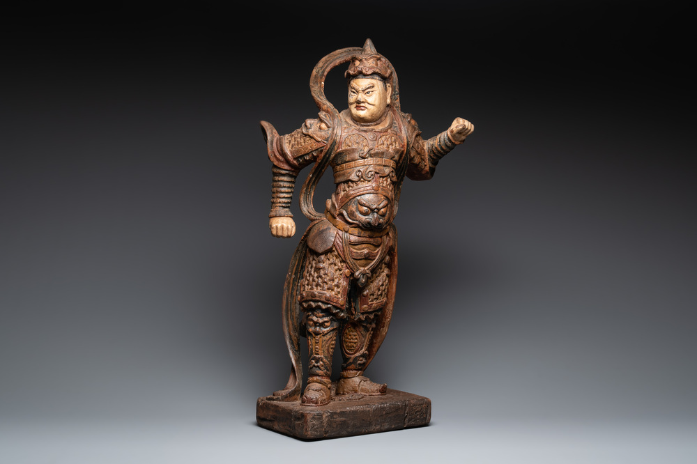 A large Chinese polychrome-lacquered wooden figure of a Guardian King, 18/19th C.