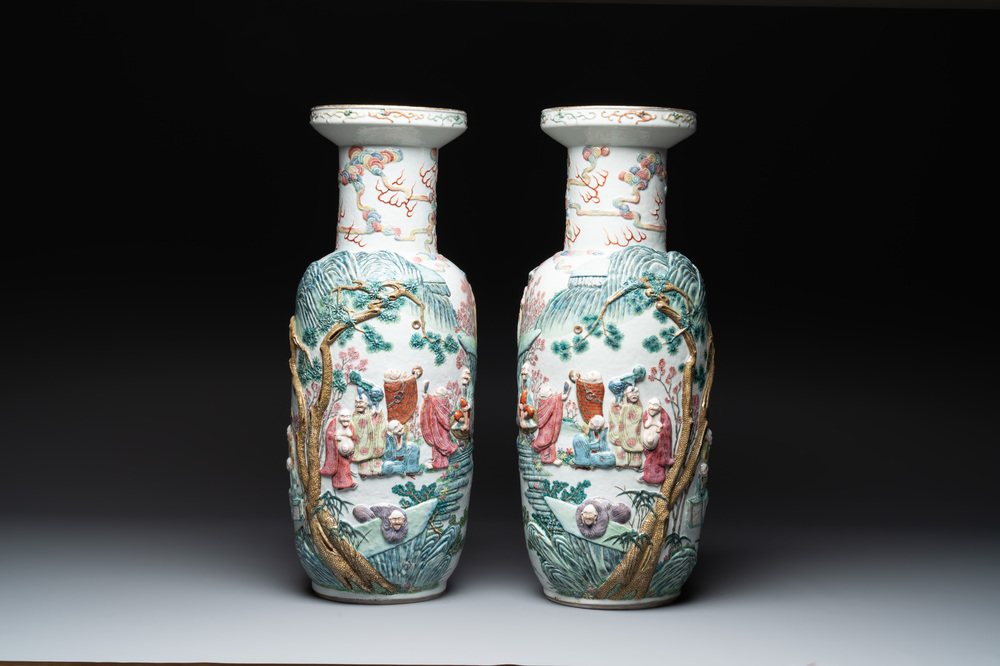 A pair of Chinese famille rose '18 luohan' vases with relief design, 19th C.