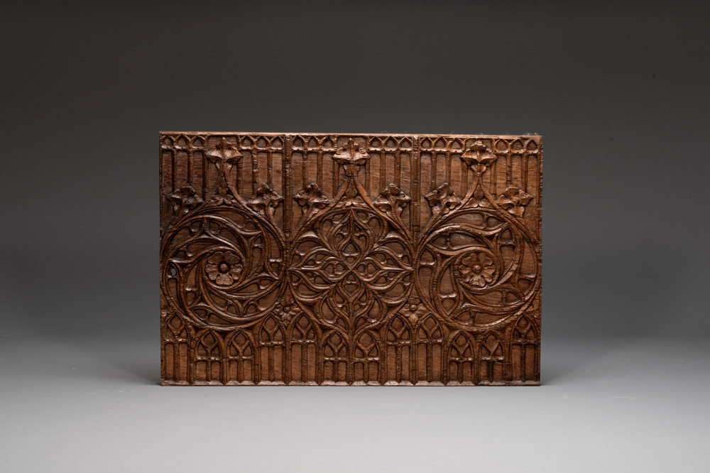 A Gothic carved oak front panel of a chest with arcades and rosettes, France, late 15th C.