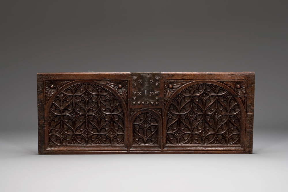 An ornately carved front panel of a late Gothic oak chest, presumably France, 15th C.