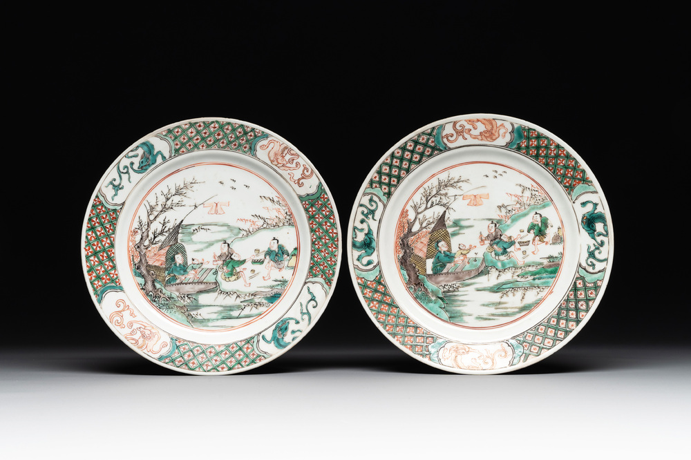 A pair of Chinese famille verte plates with figures along the riverside, artemisia leaf and ding mark, Kangxi