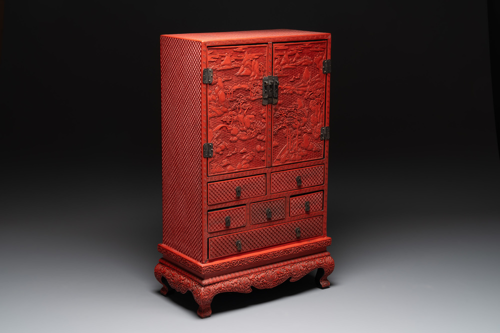 A Chinese cinnabar lacquer 'mountainous landscape' cabinet on a stand, 19th C.