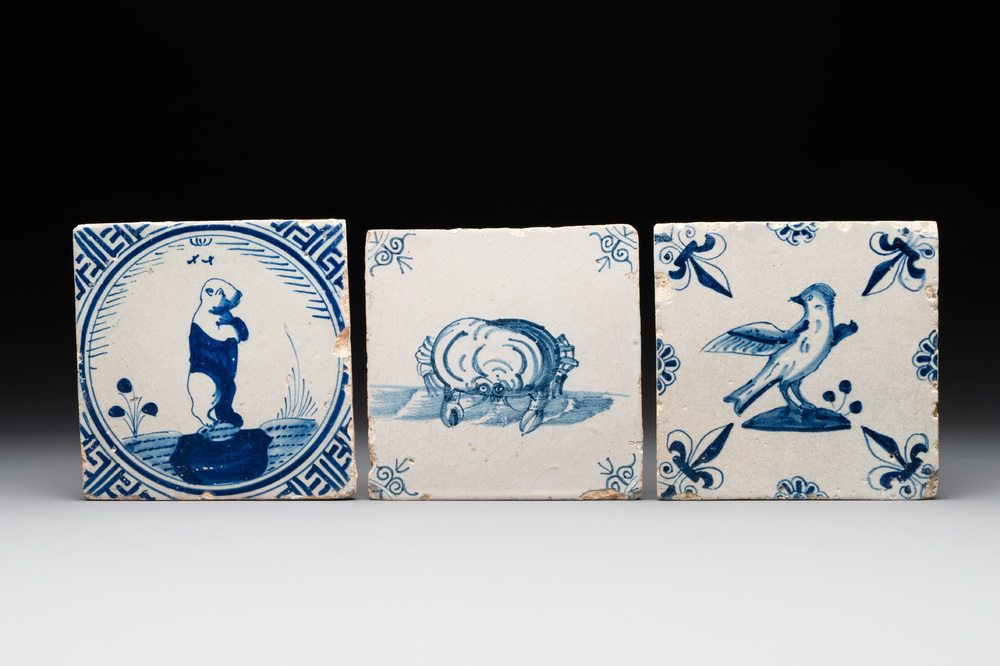 Three blue and white Dutch Delft tiles with a bear, a crab and a bird, 17th C.