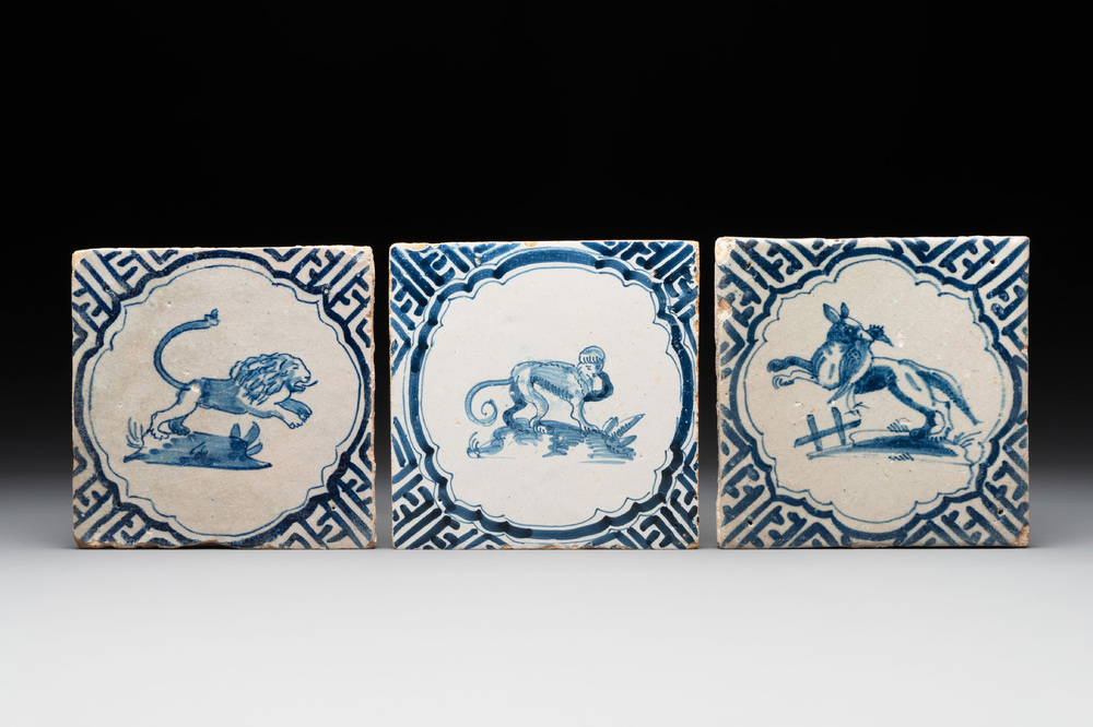 Three blue and white Dutch Delft tiles with a monkey, a lion and a fox with their prey, 17th C.