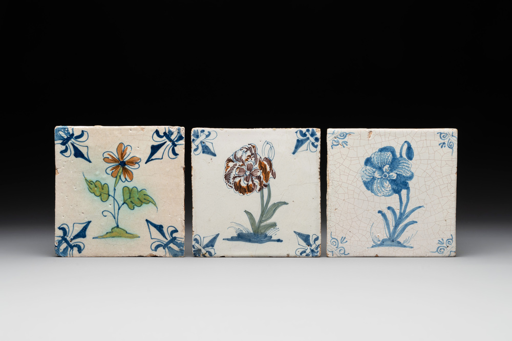 Two polychrome and one blue and white Dutch Delft 'flower' tiles, 17th C.