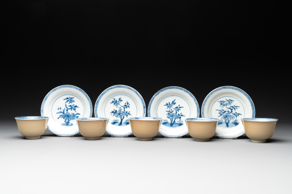 Five Chinese caf&eacute;-au-lait-ground blue and white cups and four saucers, conical shell mark, Kangxi